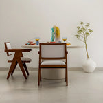 Load image into Gallery viewer, Elegant microplaster round dining table styled with decorative centerpieces for a cozy dining experience.
