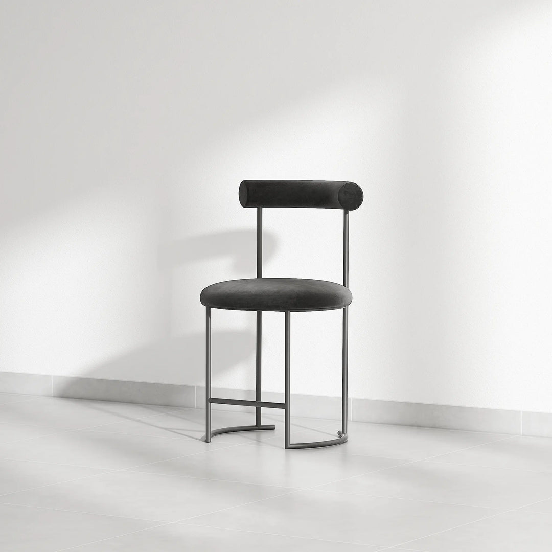 The Claudia round dining chair, designed to complement any dining room with its unique style and comfort.